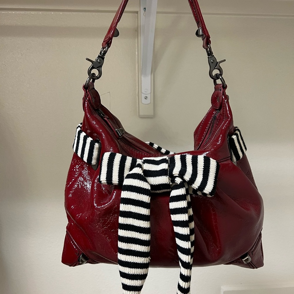 Betsy Johnson red patent leather handbag with black and white striped bow.